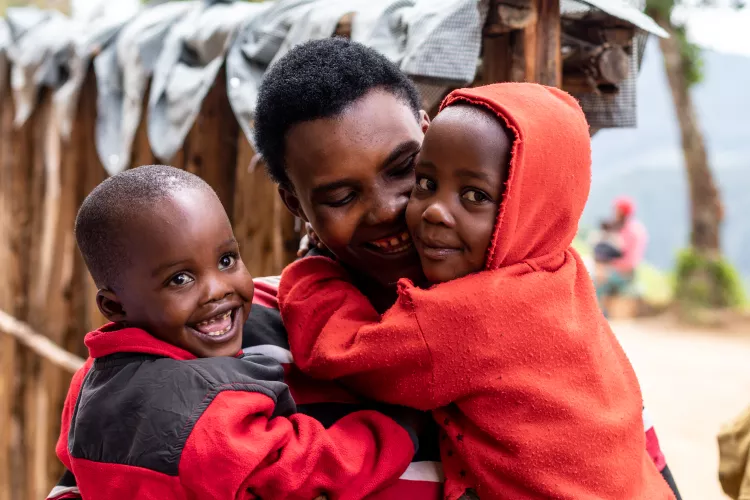 A mother holding her twin children
