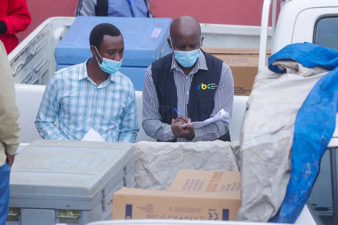 An RBC staff member verifies that the right allocation of COVID-19 vaccines has been made as the vaccines are prepared for transportation to district hospitals