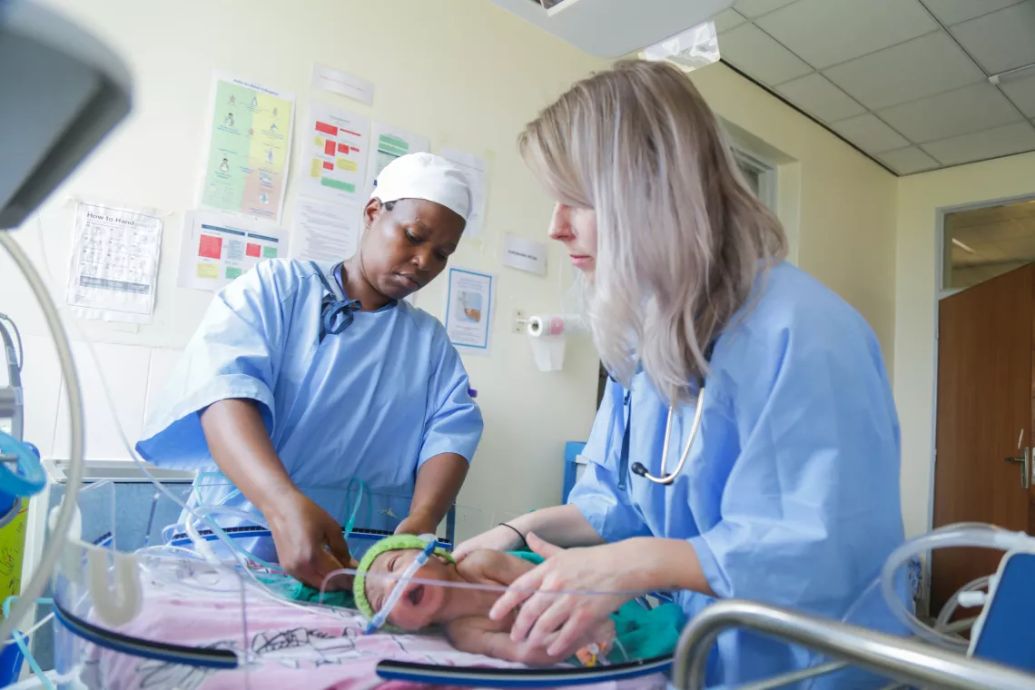 Jacqueline works alongside Dr. Evelyn Little, a mentor from the UK, to check the vital signs of a prematurely born infant.