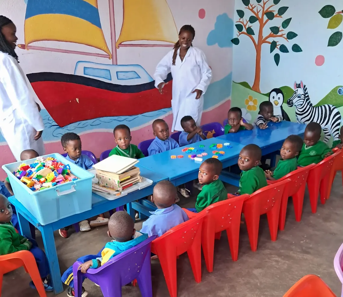 children and cargivers in a classroom