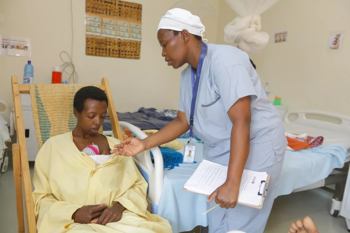 Jacqueline tends to new mother Rachel as she practices 'kangaroo care' to help her premature baby grow and thrive.