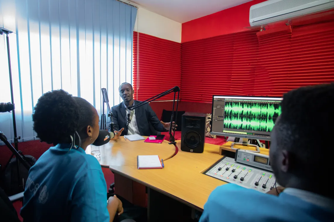 Rebecca and Divin interview Lambert Hategekimana, Child Protection Specialist with the National Child Development Agency, for World Children's Day.