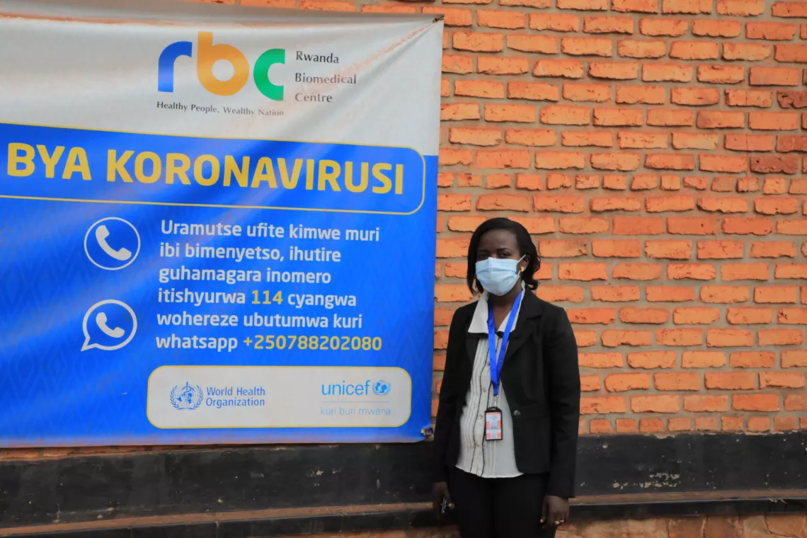 Odette Mpungirehe, a UNICEF consultant conducting risk communication and community engagement activities to fight COVID-19, stands near the market in Kirehe District, Rwanda.