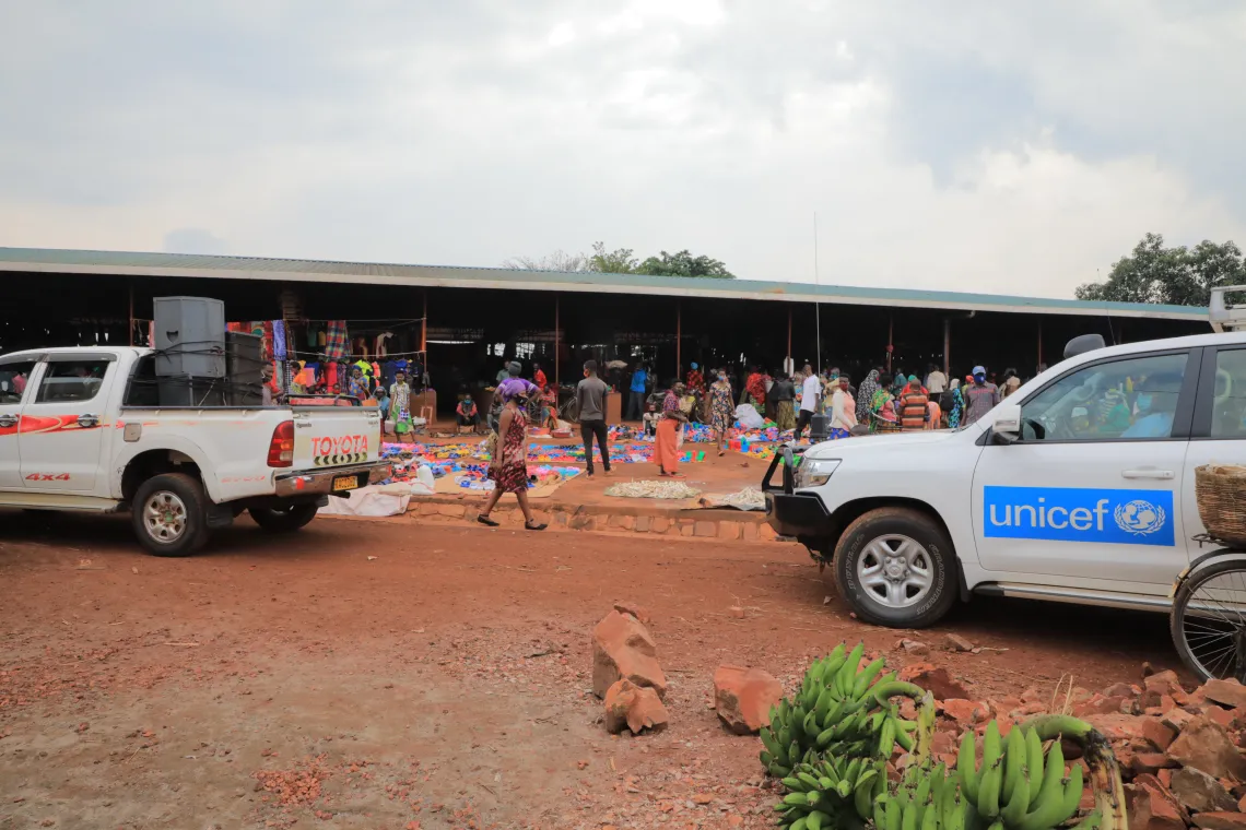 Odette Mpungirehe, a UNICEF consultant conducting risk communication and community engagement activities to fight COVID-19, briefs youth volunteers near the market in Kirehe District, Rwanda.