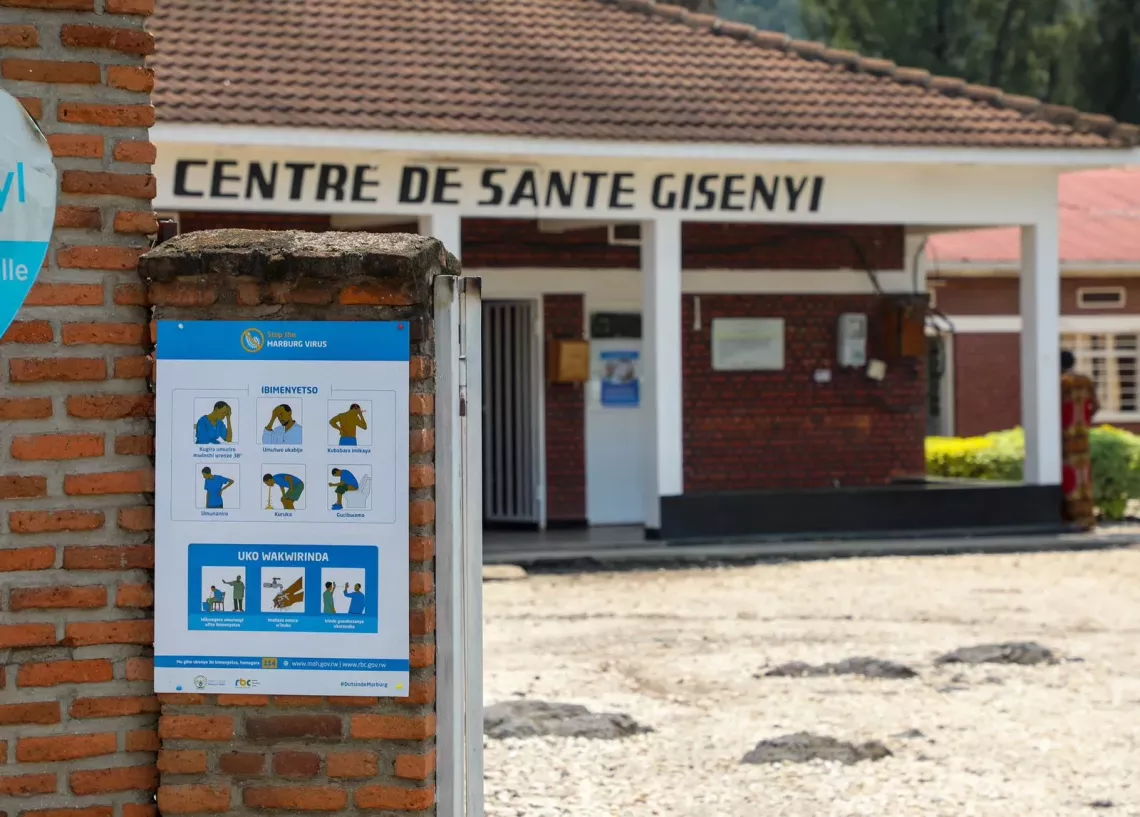 A sign poster displayed outside a health center showing Marburg Virus Disease prevention information 