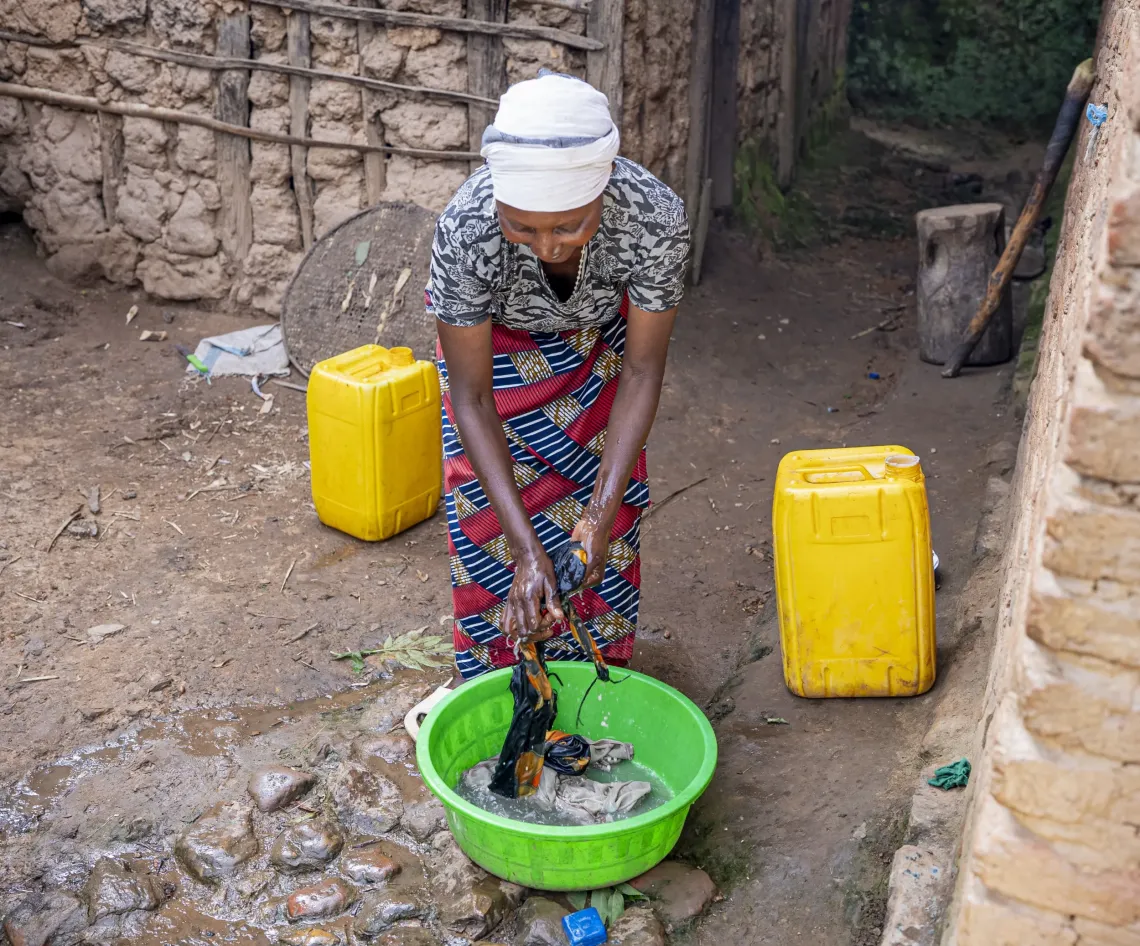 a woman washing cloths from home