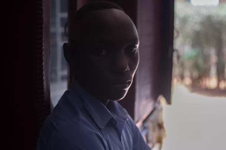 Boy in Rwanda with face hidden in silhouette