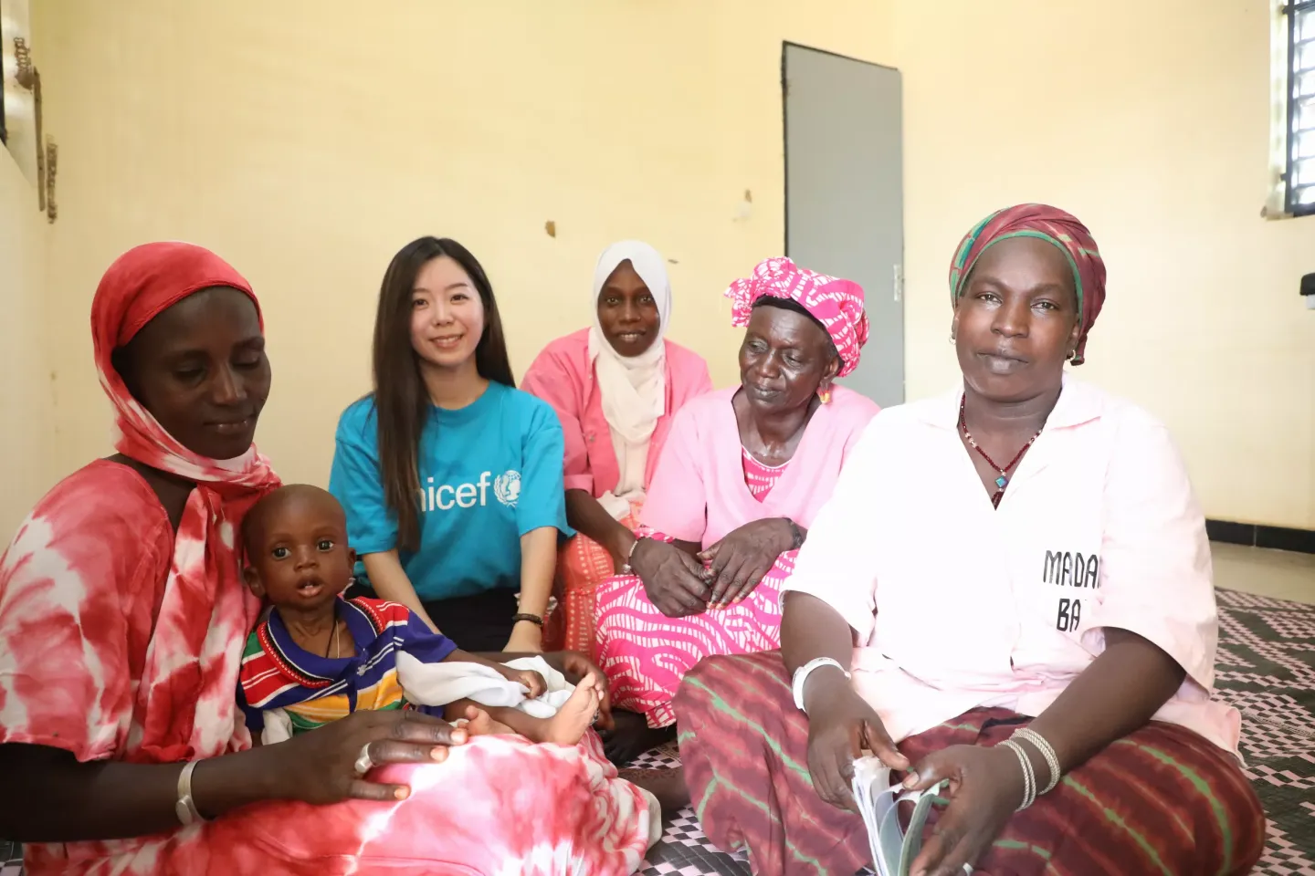 Natsuki Kawai in Podor with a mother and her child 