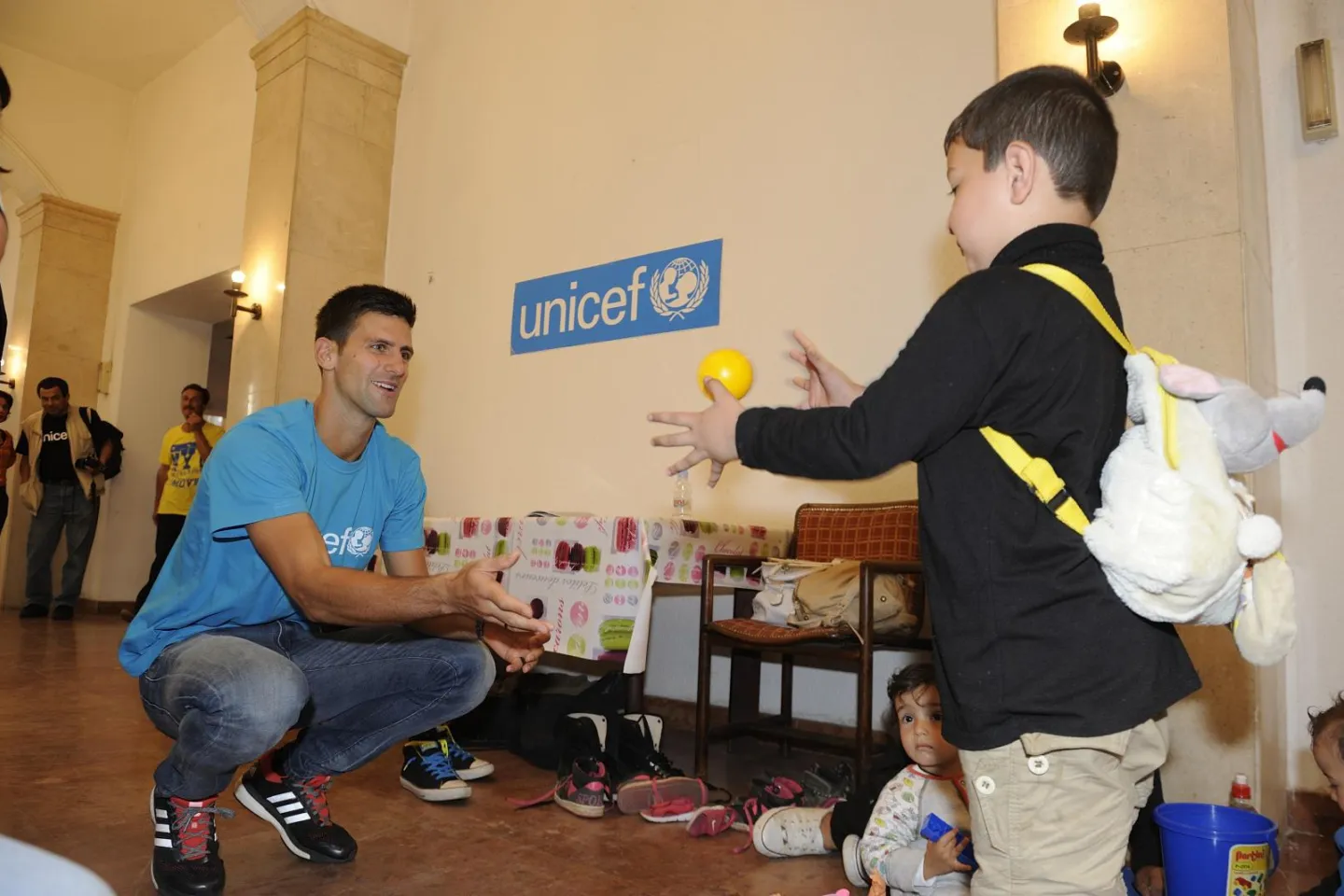 UNICEF Goodwill Ambassador Novak Djokovic plays with Boset at the UNICEF-supported child-friendly space in Belgrade. 