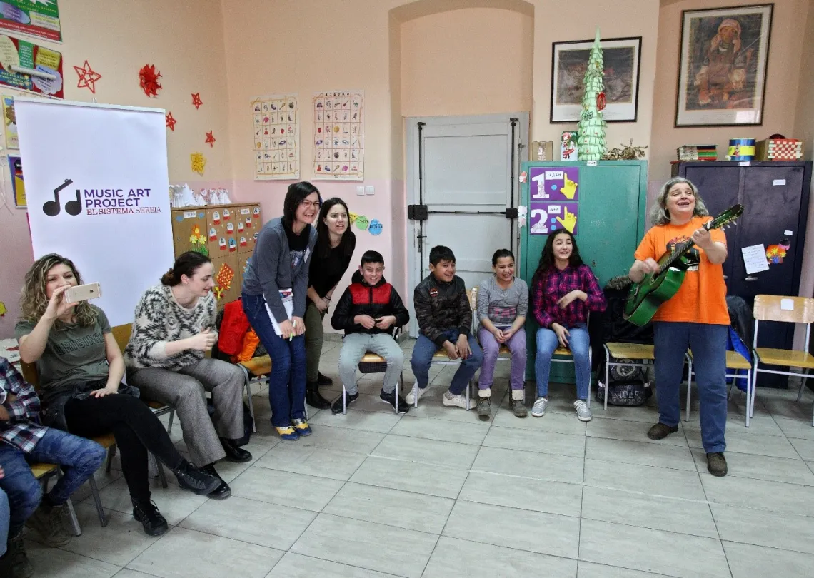 Snezana Aleksic playing guitar during the music class