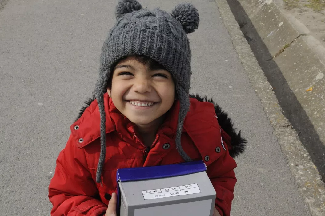 Migrant child with a box