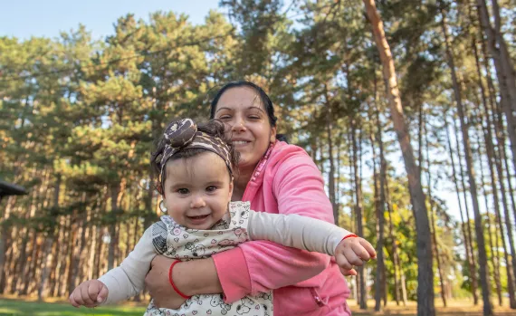 moher holding her young daughter and laughing