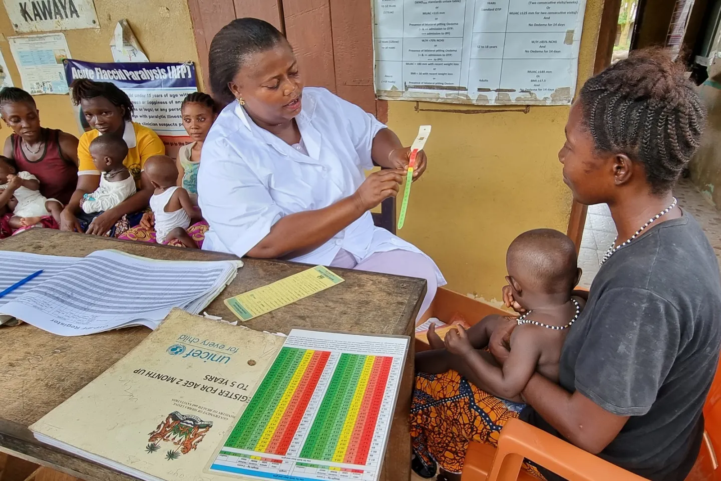 A nurse consults with the mother of a child at a health facility in Sierra Leone
