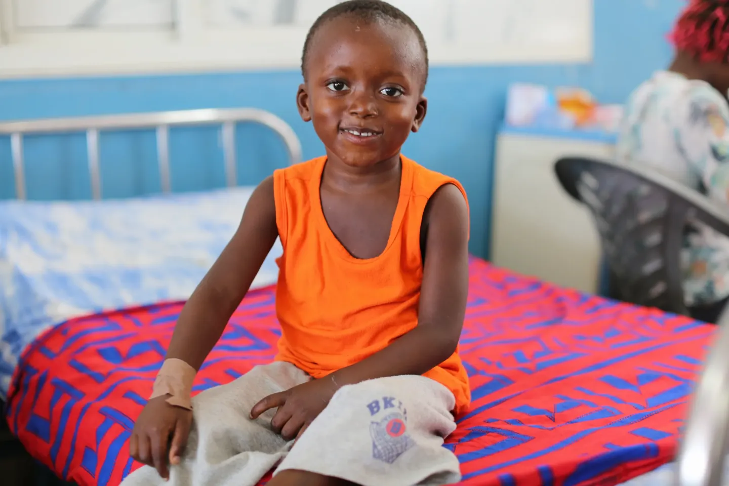 4-year-old Gibrilla sits on his admission bed at the Ola During Children's Hospital, a few days after being weaned off oxygen.