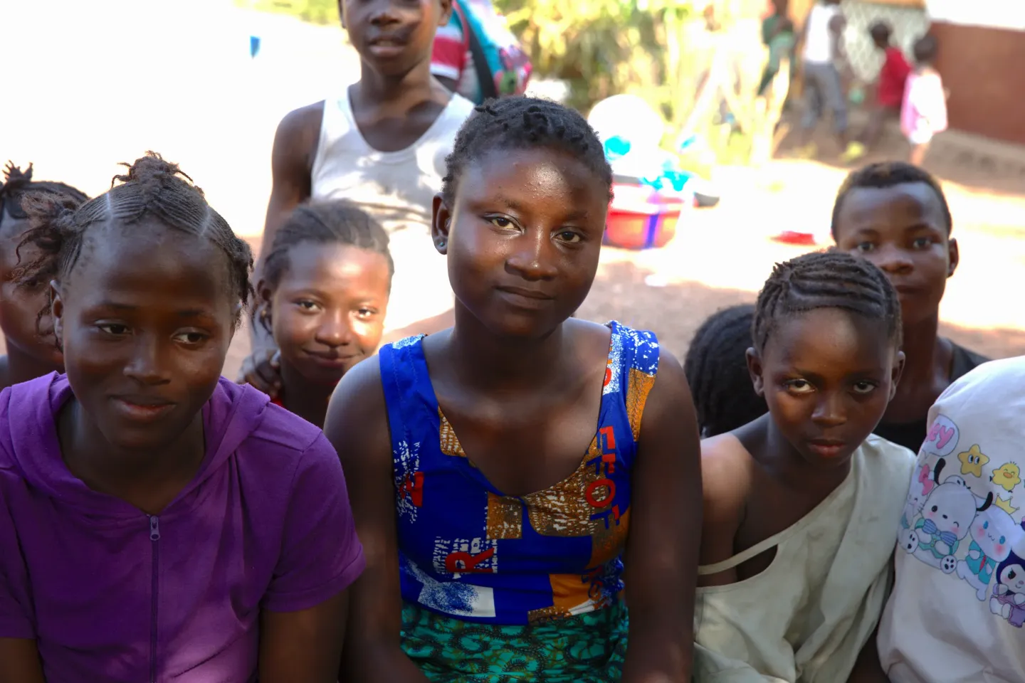 Kadiatu Bangura (middle) sits with other adolescent girls who are beneficiaries of the Cash Plus programme in Kapairoh village, Kambia District 