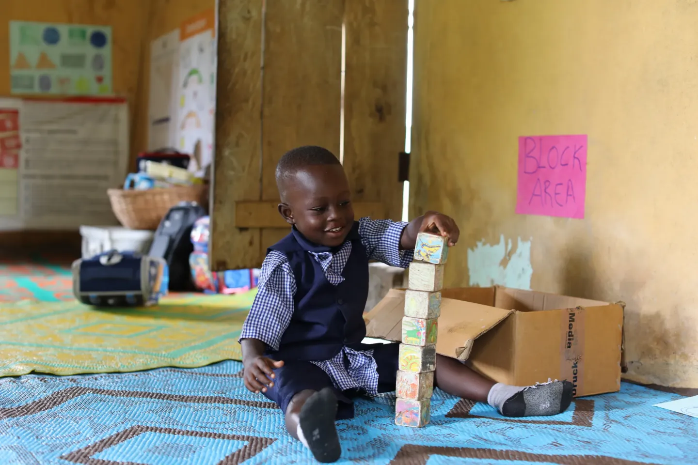 A child plays with bricks inside a UNICEF-supported early childhood development centre