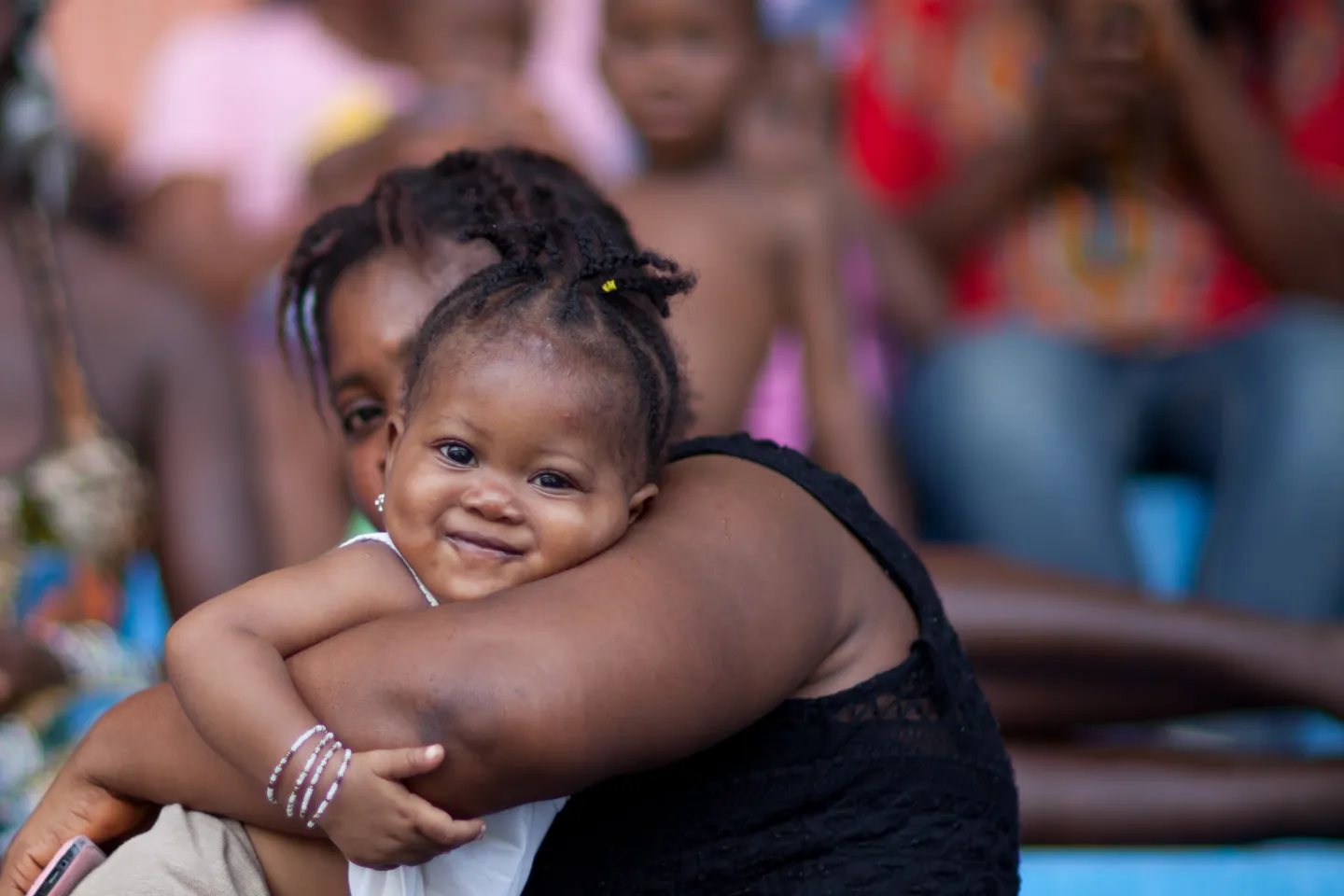A mother carries her baby at the Siaka Stevens Stadium in Freetown.