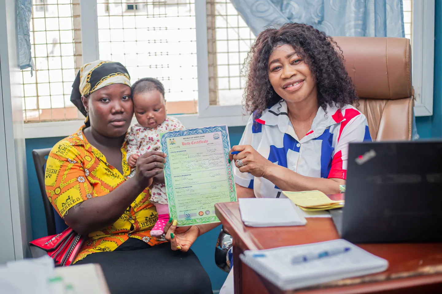 A baby is issued a birth certificate in Freetown, Sierra Leone