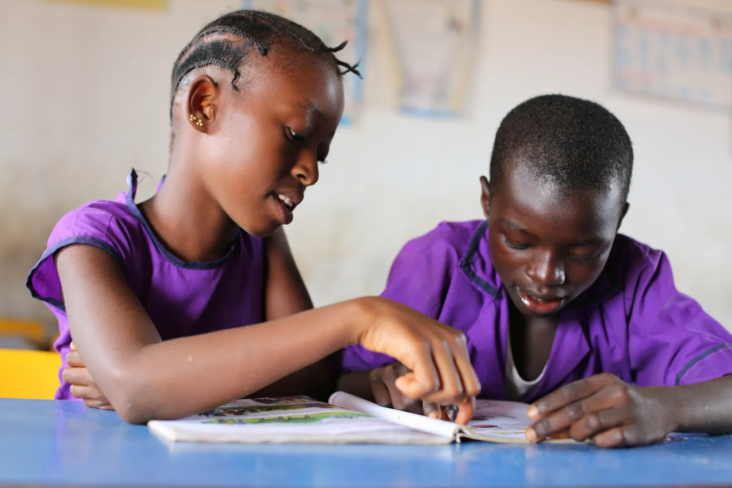 Two pupils read a book in a classroom in Sierra Leone