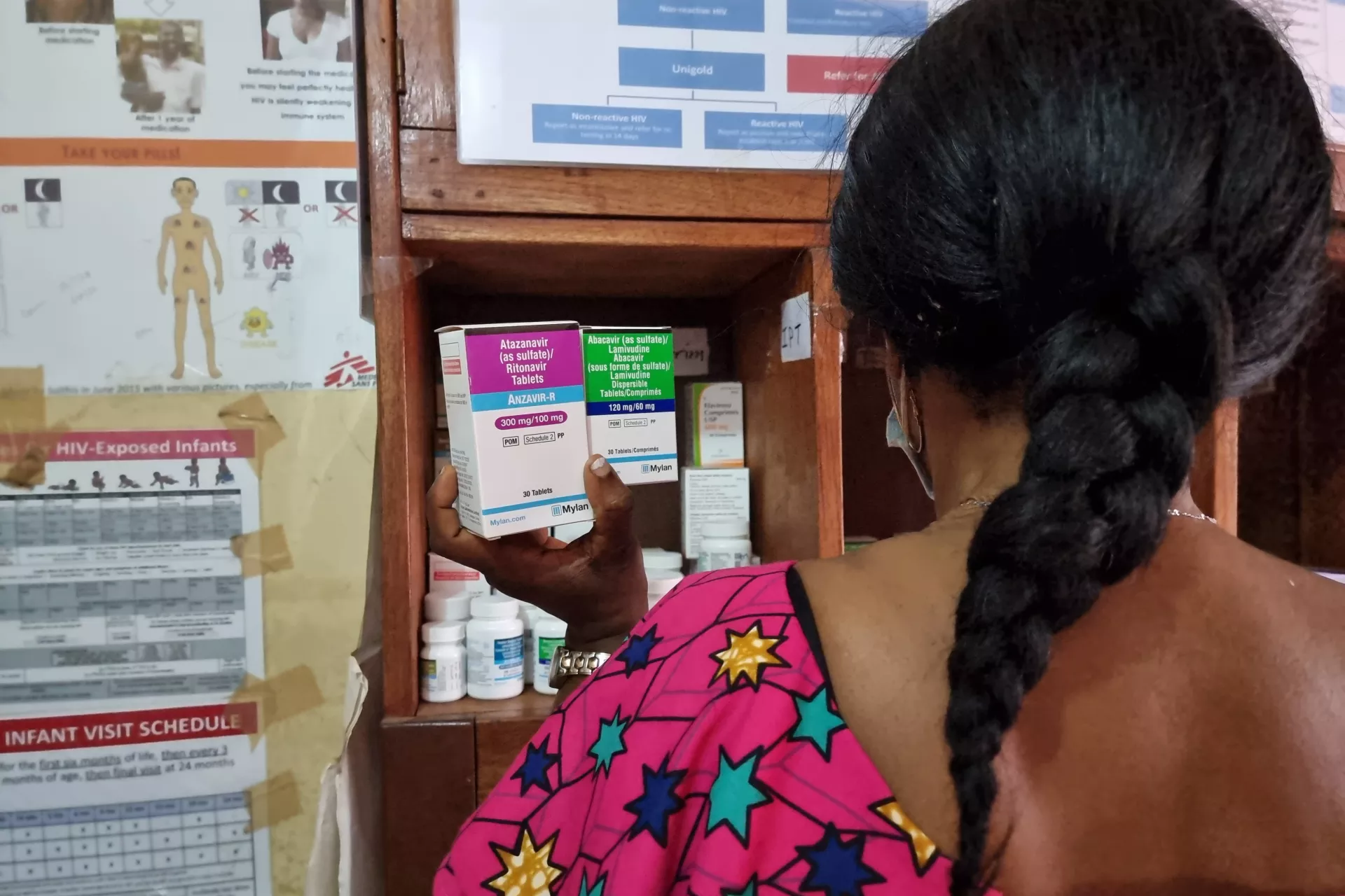 A woman sits inside a health centre in Freetown, Sierra Leone