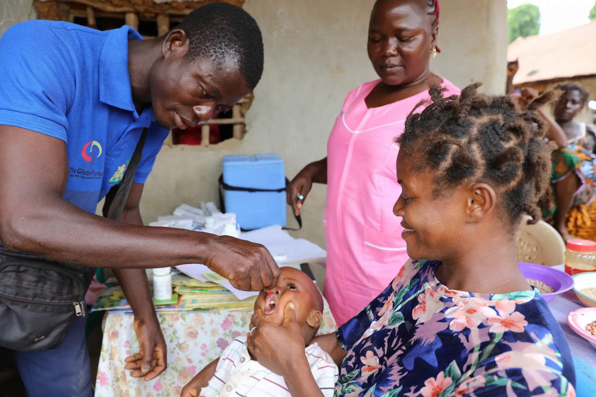 Mohamed Kamara, a Community Health Worker (CHW), administers Vitamin A to an under-five child during a community outreach session in Njagbahun village, Moyamba, District