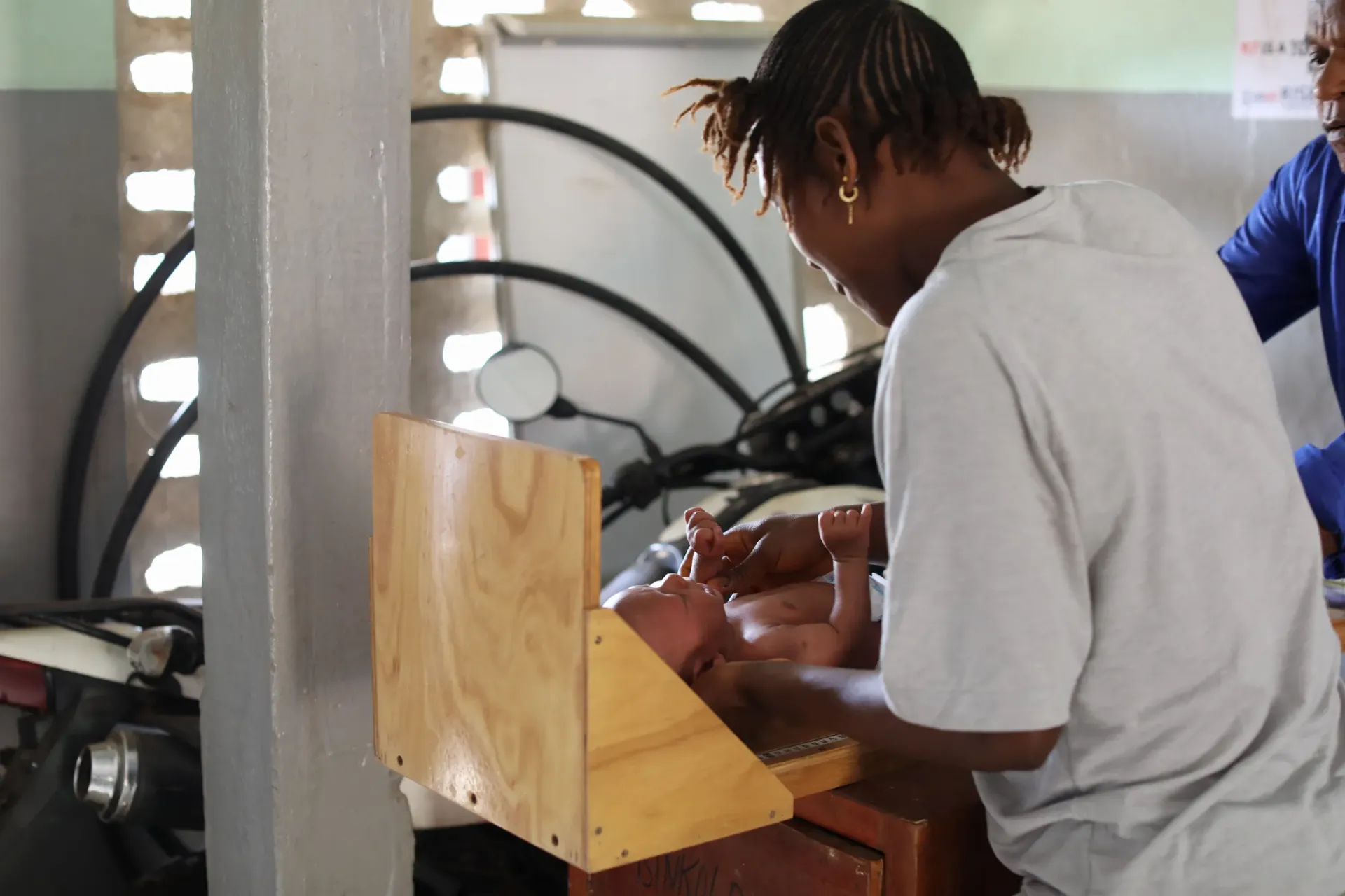 Seven-months old baby Isatu&rsquo;s height is being measured as part of the processes to determine her nutritional status at the Binkolo Health Centre, Bombali District, northern Sierra Leone. 