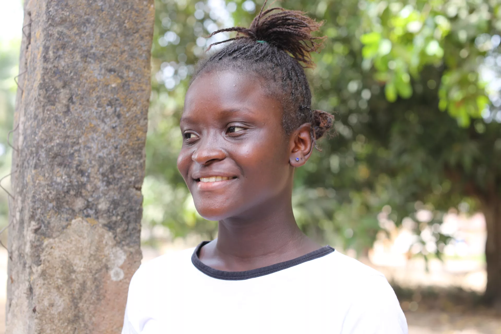 A girl stands outside her home in Kambia, northern Sierra Leone