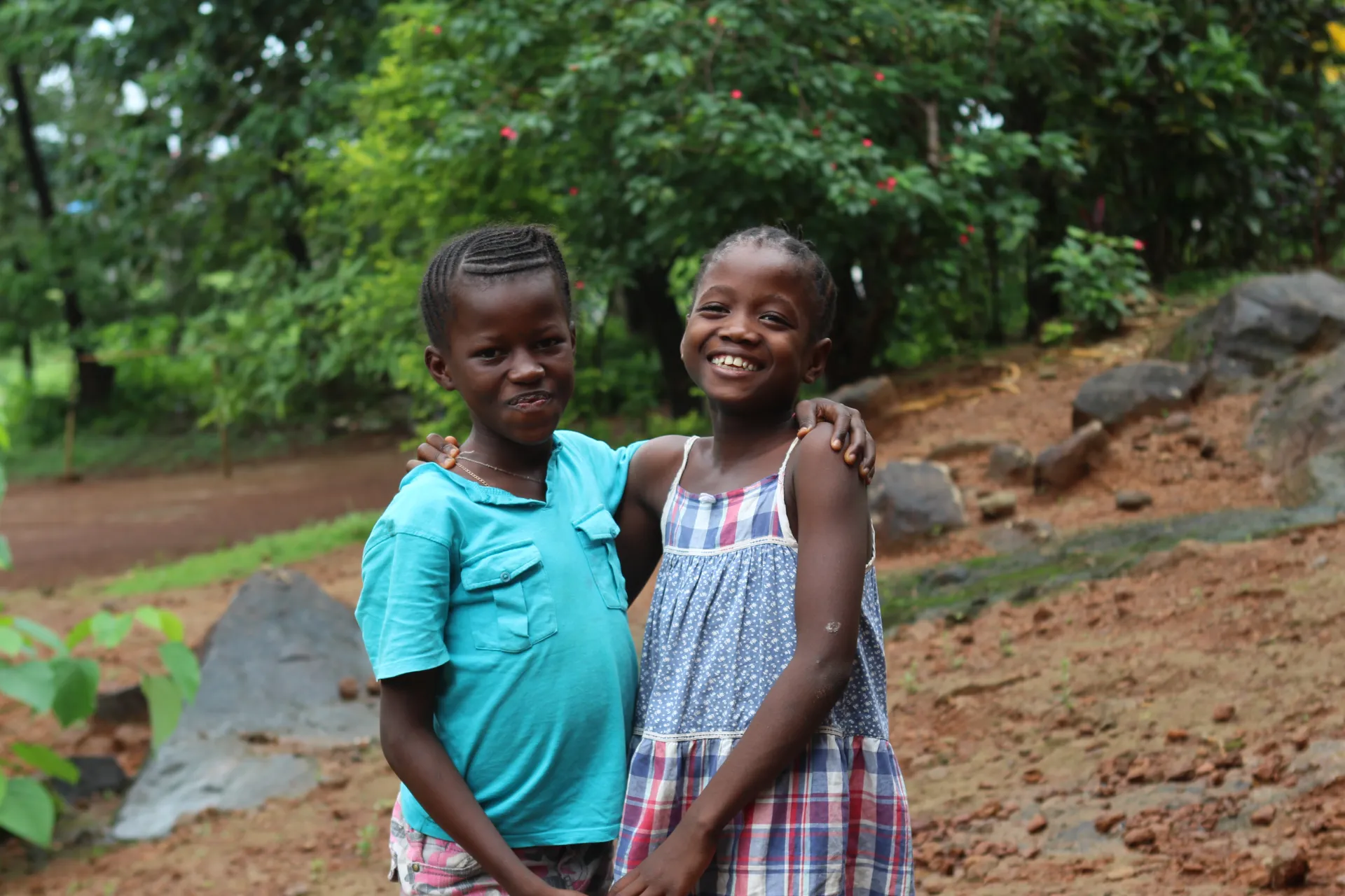 Two girls stand outside an orphanage in Grafton community, western Sierra Leone.
