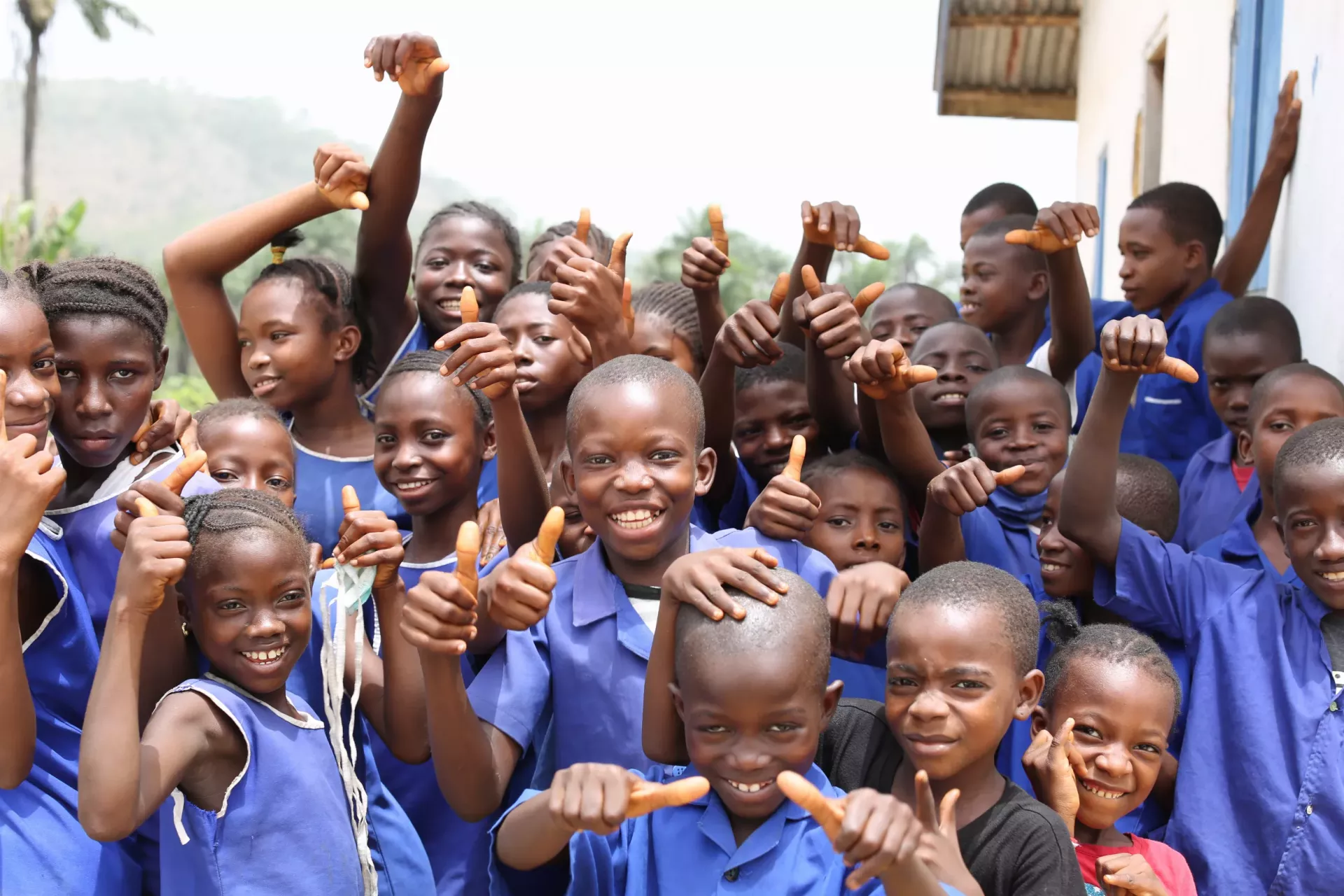 A group of school children stand inside their school premises in Sierra Leone.