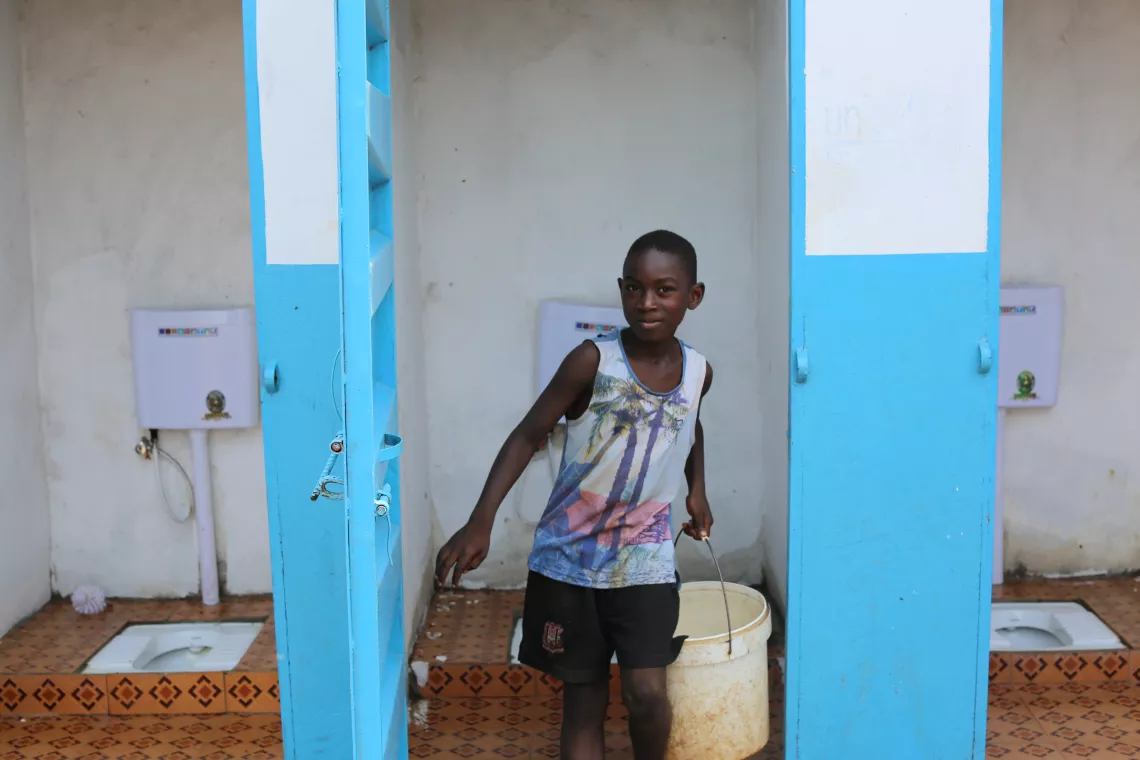 A boy comes out of a toilet in Freetown, Sierra Leone