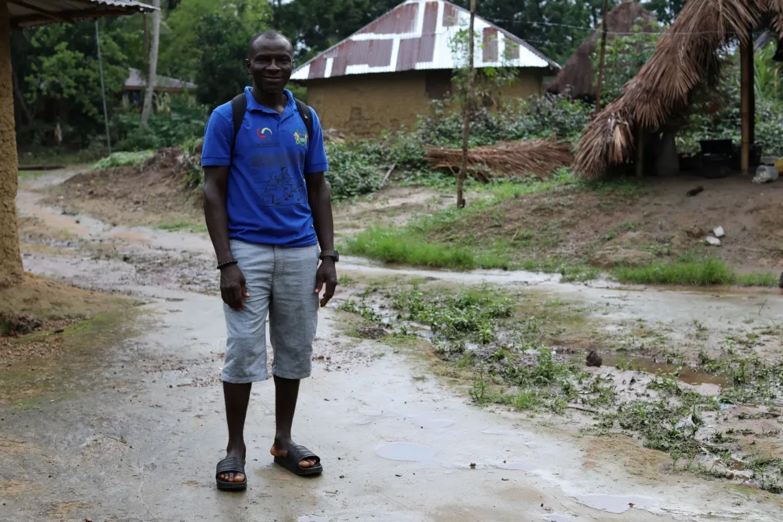 Community Health Worker Yusuf Musa heads home after a round of home visits at the Kpatema Community. 