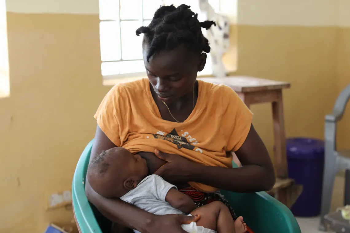 Amie Konjor breastfeeds her 2-month-old baby inside the Futa Pejeh Community Health Centre during a routine visit. 