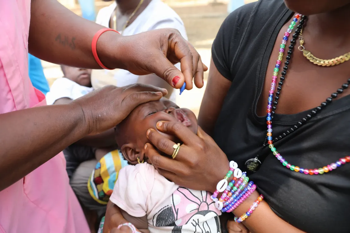 Six-month-old Haja gets a dose of Vitamin A at the Rokonta Community Health Center. 