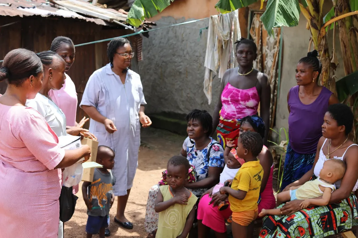 Jenevia and her team of health workers sensitizes a group of mothers with their babies on the importance of vaccination during an outreach exercise in Waterloo community 