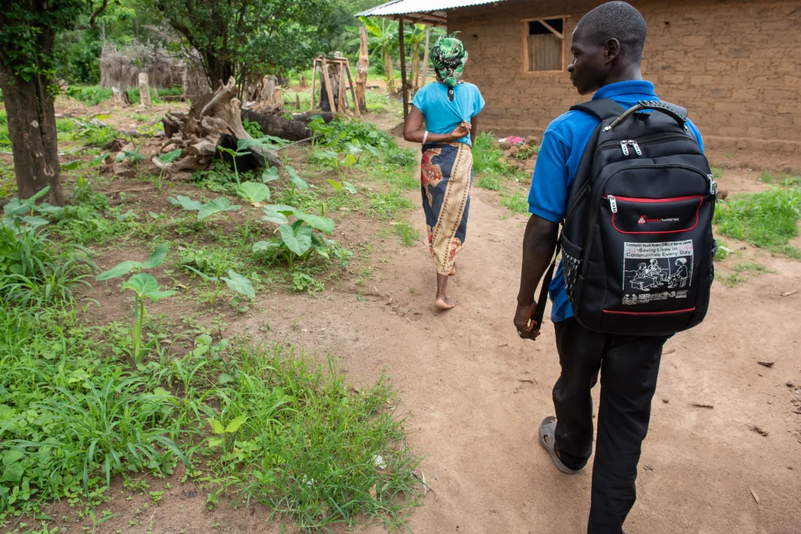 Musa Jawara walking through his community of Hurgon, where he has served as a Community Health Worker for the past three years.