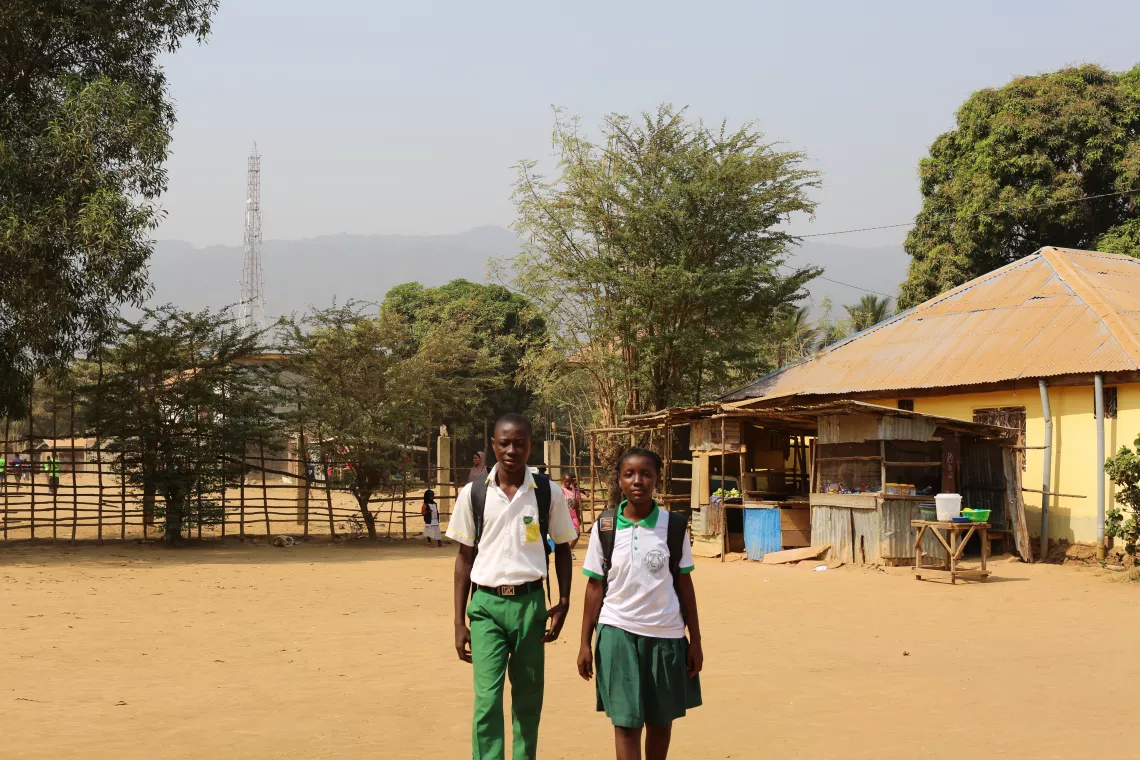 A boy and a girl walk to school.
