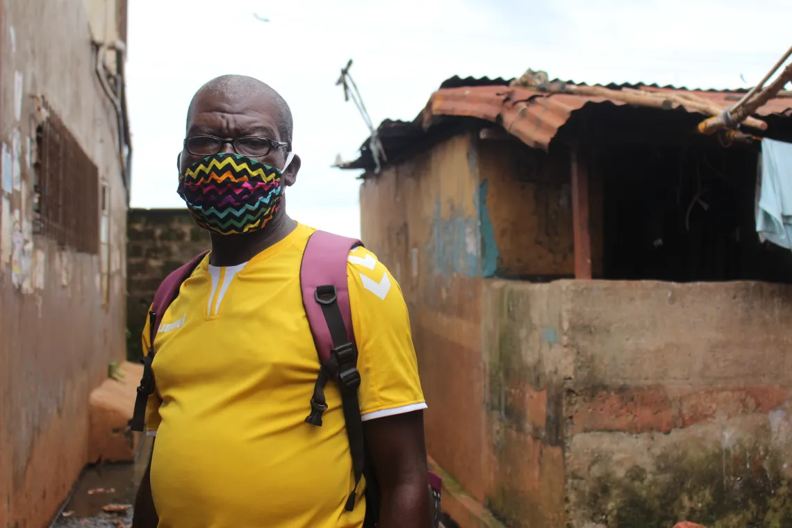 A man stands by a house in Freetown western Sierra Leone
