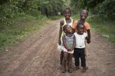 Four young girls stand on a road in Badu village, Kono district, eastern Sierra Leone.