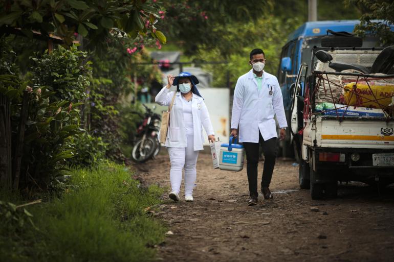 Health workers walk through the streets of Matagalpa, a city in northern Nicaragua, as part of a door-to-door vaccination campaign. 