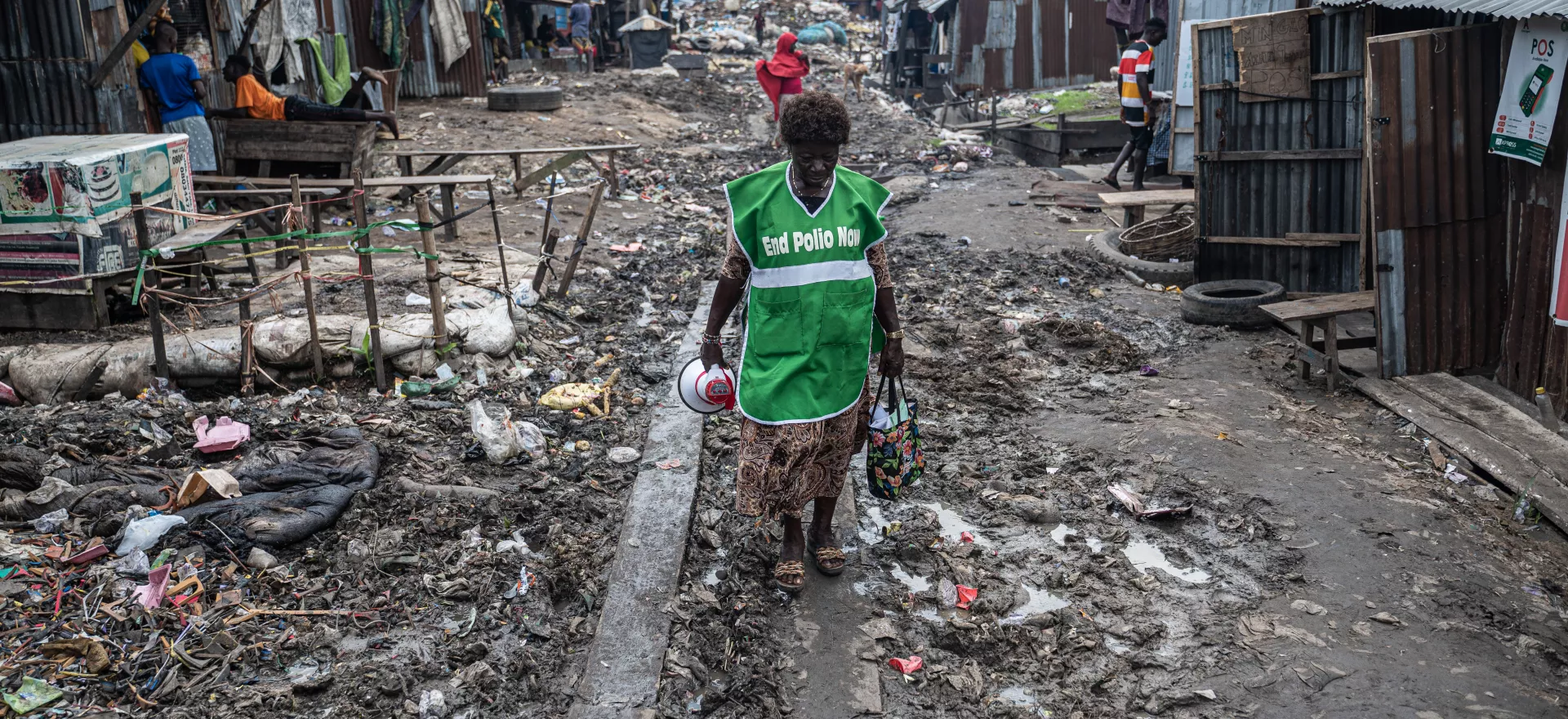 Community mobilizer Stella Adeniyi walks through the Gengere community of Kosofe Local Government Area in Lagos, Nigeria, during an integrated vaccination campaign.