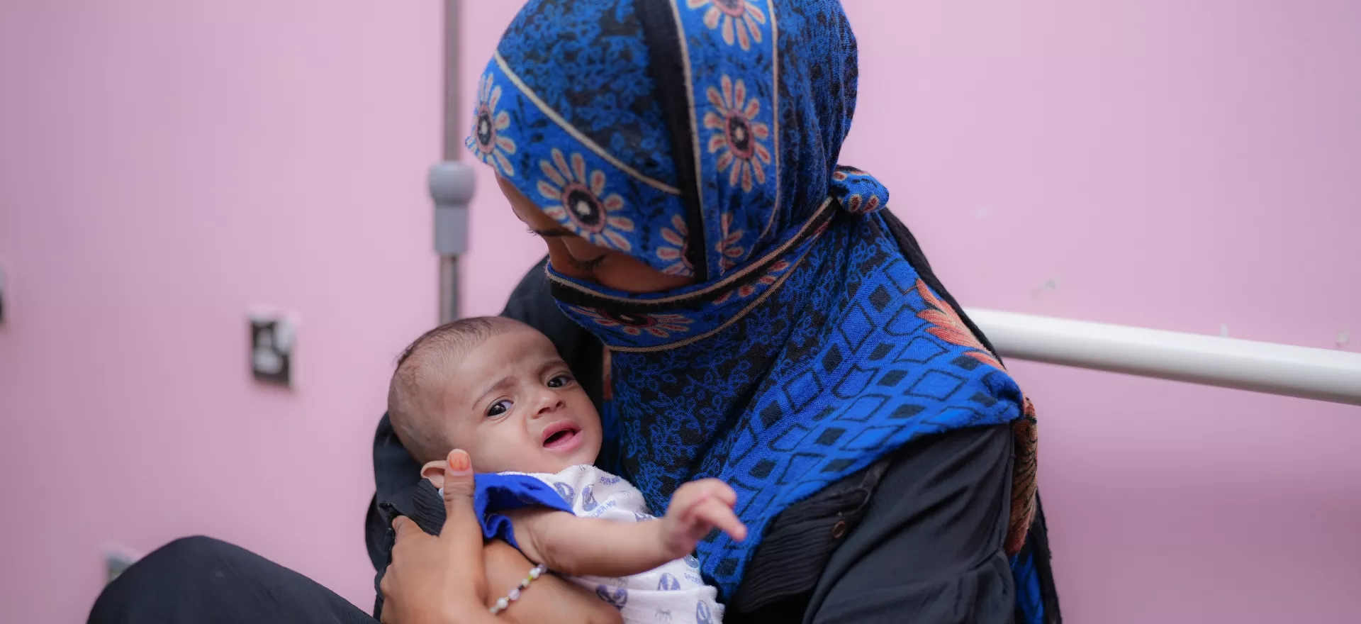 A mother holding her baby boy.