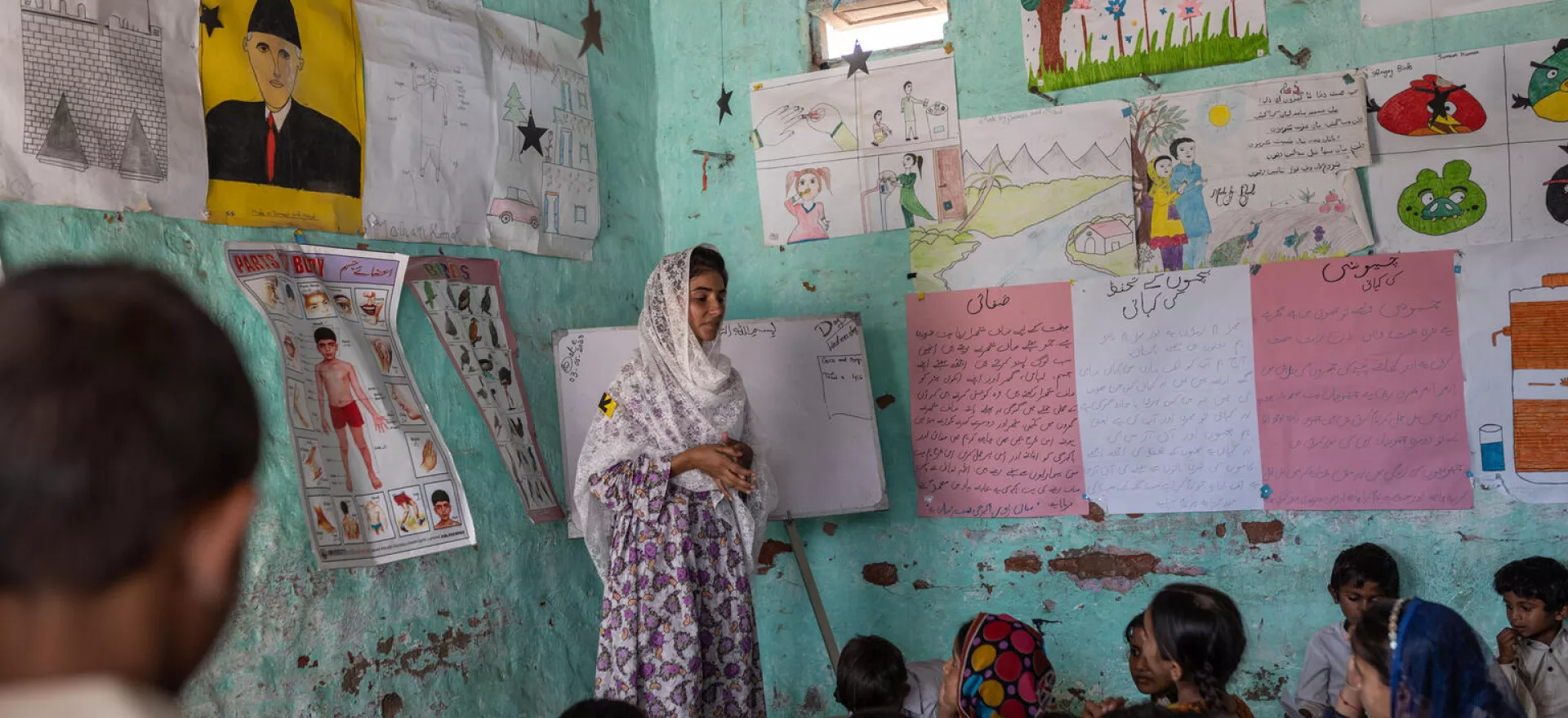 pakistan. Shan Zehra, a teacher, stands in front of students at a the UNICEF-supported child friendly space in Sindh Province.