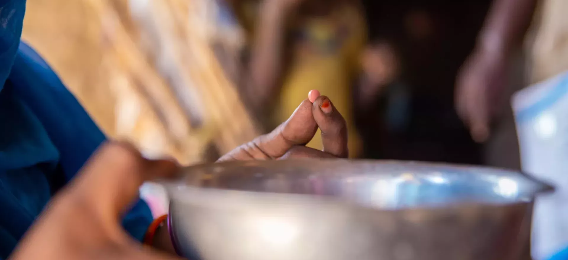 Sudan. A mother prepares to take an iron tablet during a UNICEF-supported door-to-door nutrition campaign in Kassala state.