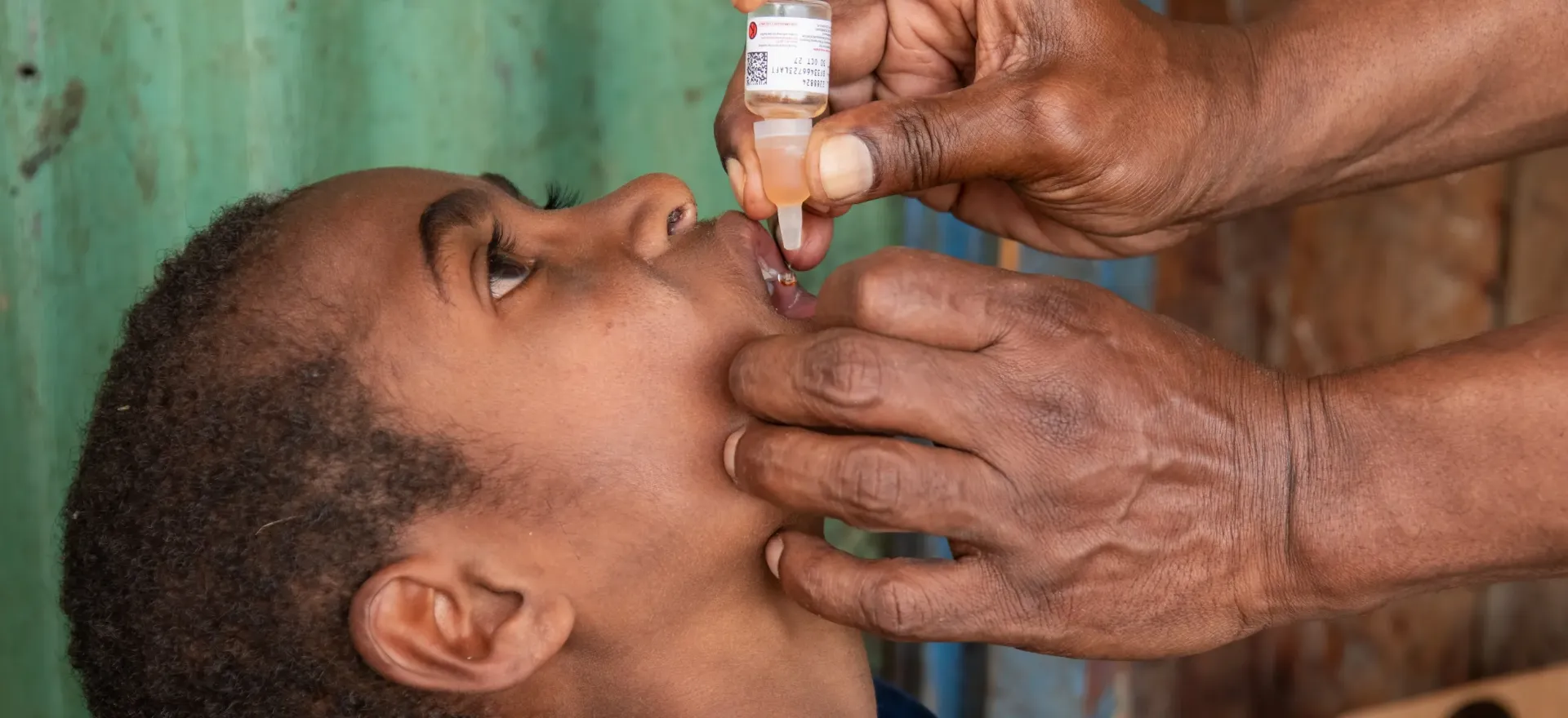 A child receives an oral vaccination