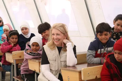 UNICEF Executive Director Catherine Russell sits with children in a classroom in Aleppo, Syria.