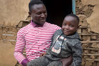 Democratic Republic of the Congo. A man holds a child.