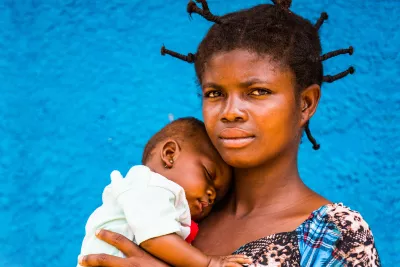A mother holds her sleeping baby at a health centre in Kasai, Democratic Republic of the Congo, DRC.
