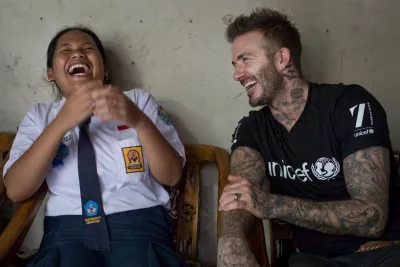 UNICEF Goodwill Ambassador David Beckham smiles with Sripun, 15, at her home in Semarang, Indonesia, March 27, 2018.
