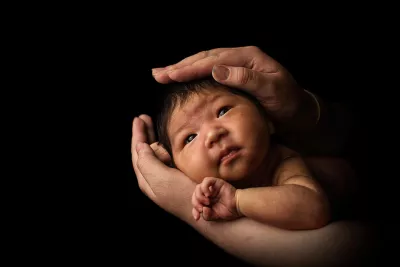 Mother Bayarmaa with her baby Uuriintsolmon (2 weeks), in her living room in Murun, Mongolia 