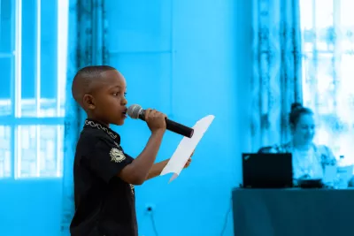 Manzi Lucky Brian, 10, auditions for the UNICEF TEDx event in Rwanda by showing off his public speaking skills to a crowd of other children.